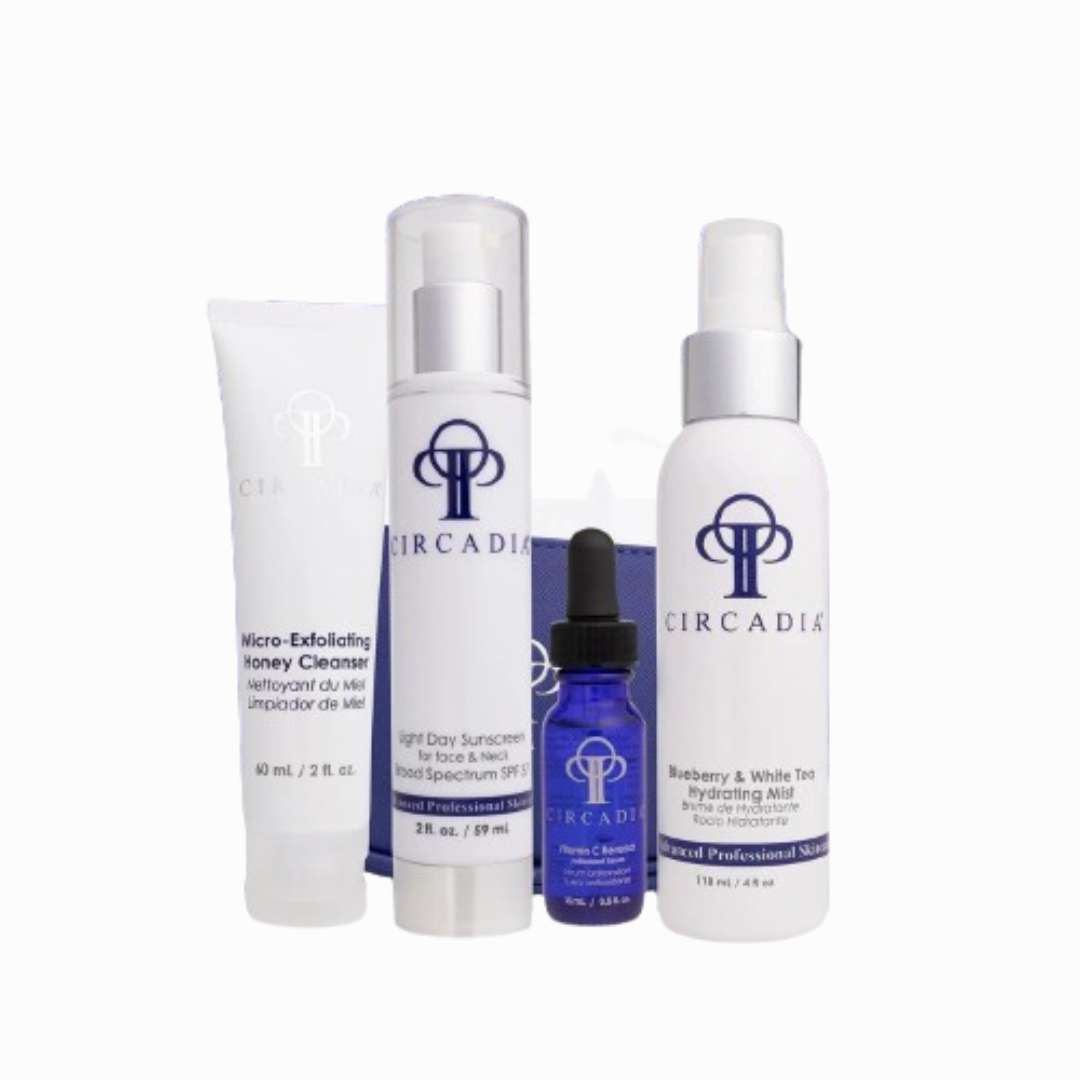 Essential Regimen Bundle Travel Kit with skincare products including cleanser, sunscreen, serum, and hydrating mist.