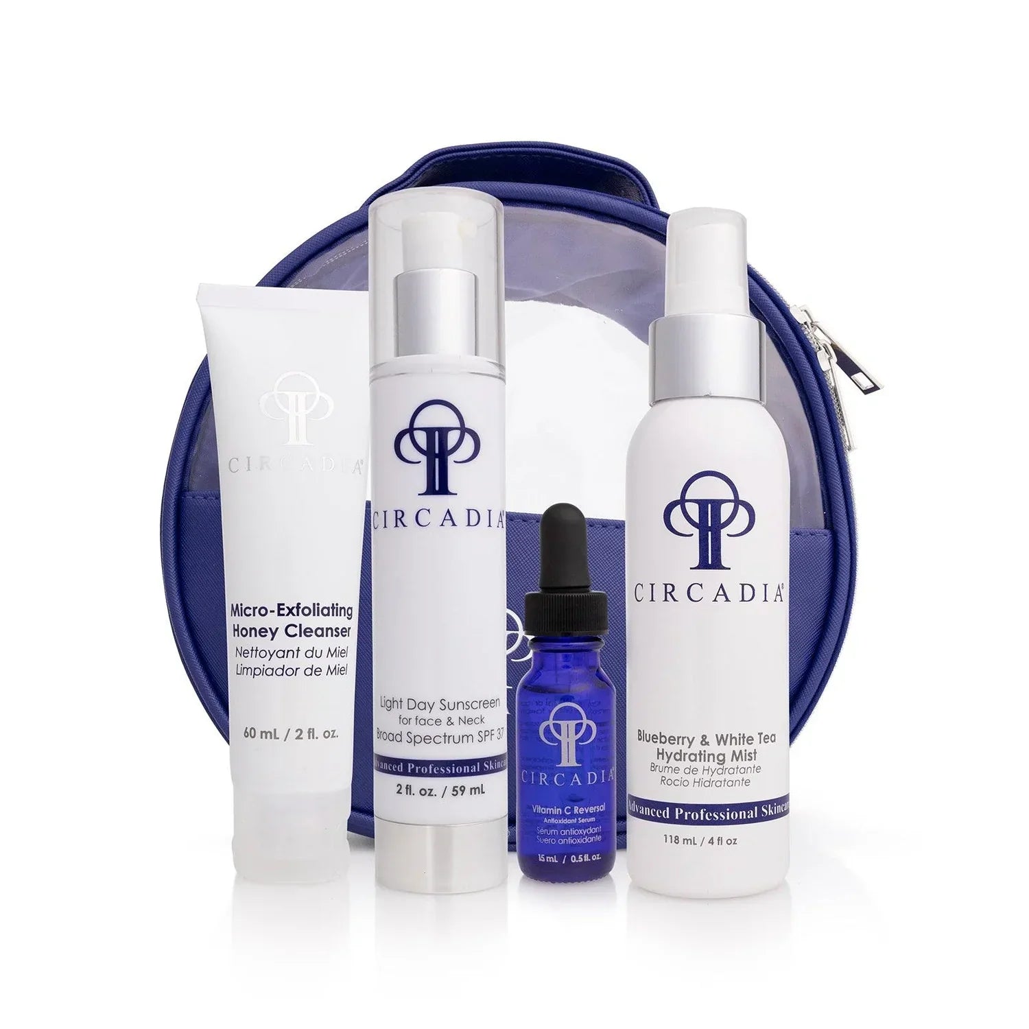 Essential Regimen Bundle with cleanser, sunscreen, serum, mist, and blue zip bag.